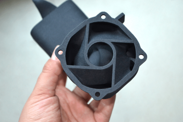 Man Holding Plastic Model Printed on Powder 3D Printer from Polyamide Powder